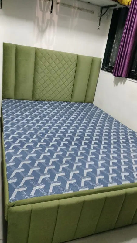 Olive green upholstered storage bed with a quilted and channel-panelled headboard