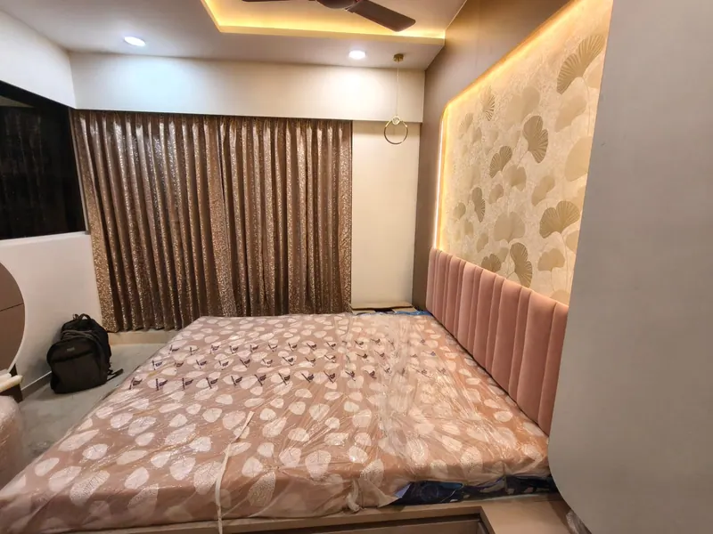 Bronze jacquard curtains in a bedroom with a blush velvet headboard and gold leaf wallpaper