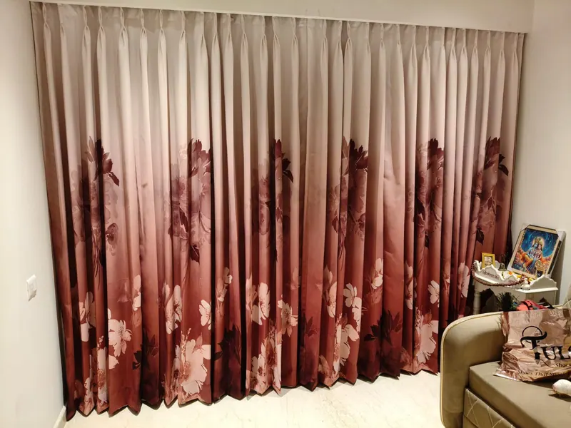 Maroon and blush ombre floral blackout curtains covering a full bedroom wall