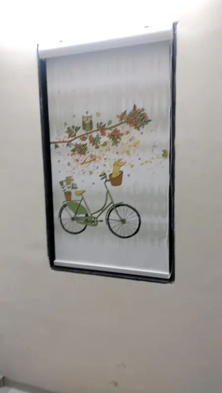 Roller blind with a bicycle and owl illustration for a child's room window
