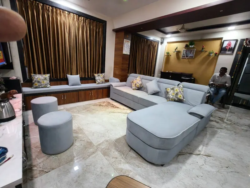 Grey velvet L-shape sofa with matching ottomans and a window seat, made to order for a Thane living room