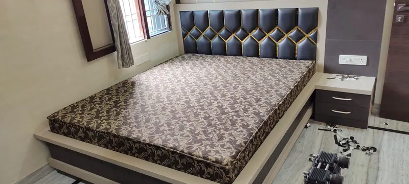 Brown and gold printed mattress made to size for a storage bed in Thane, below a black leatherette headboard with gold diamond inlay