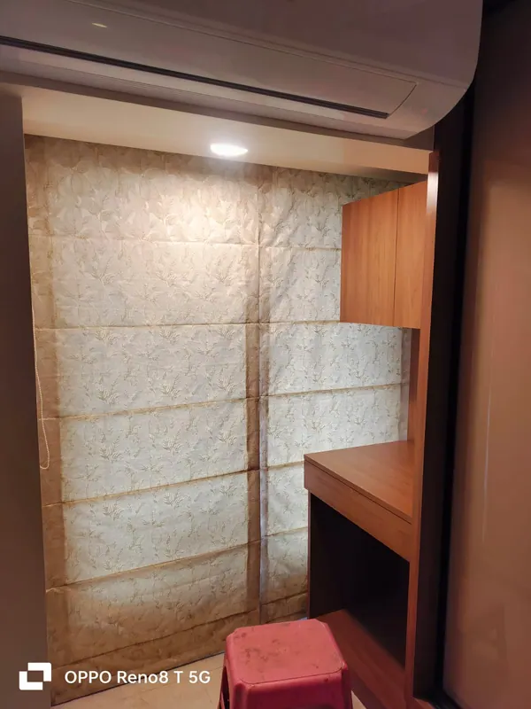 Gold jacquard Roman blind fitted over a study nook with a wooden desk