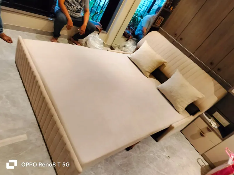 The same beige sofa cum bed opened out into a full-size bed