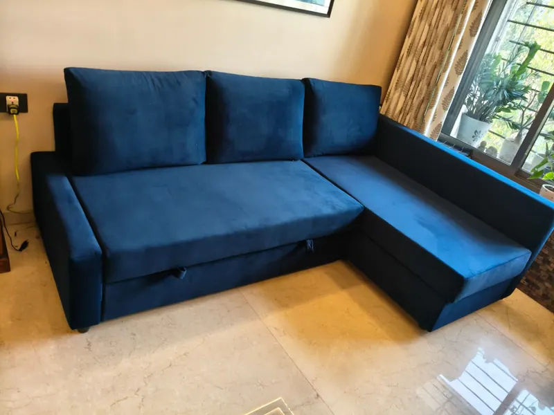 Navy velvet L-shape sofa cum bed with a storage base, in sofa position