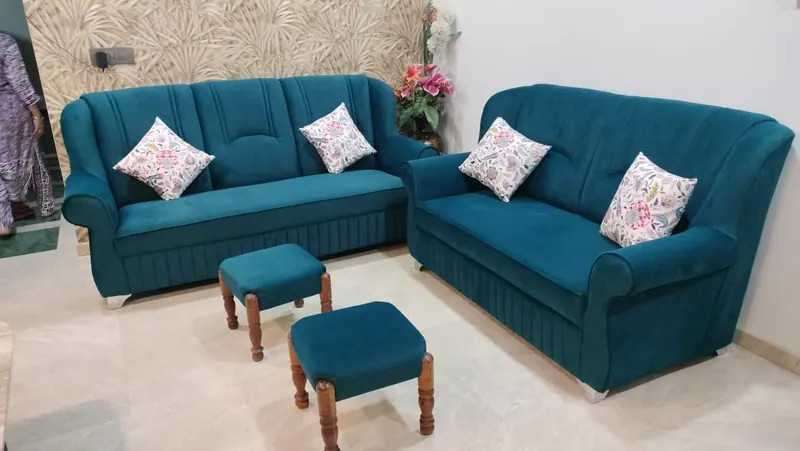 Teal 3+2 sofa set with printed cushions and matching wooden-leg stools