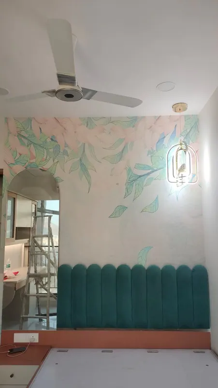 Pastel floral mural wallpaper covering a full bedroom wall above a teal scalloped headboard