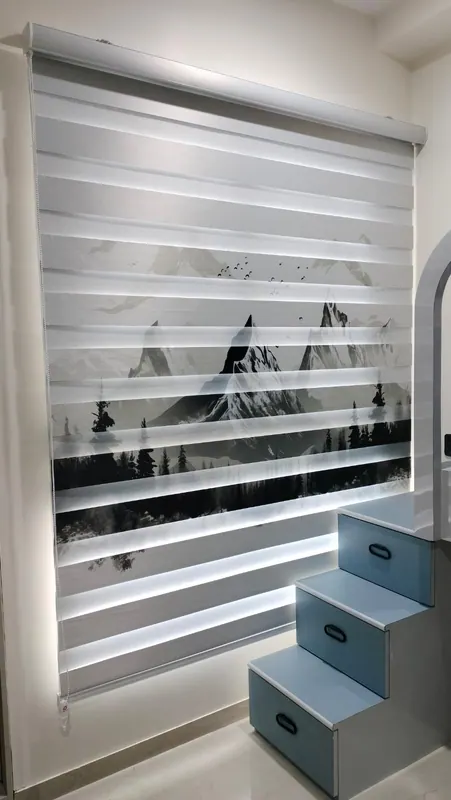 Zebra day-and-night blind with a printed monochrome mountain scene, fitted over a bedroom window